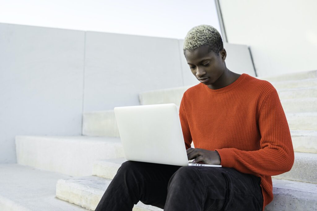 Young African american man with laptop computer.